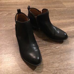 Black booties with zipper detailing.